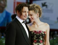 FILE - In this Sept. 5, 2015 file photo, Johnny Depp, left, and Amber Heard arrive at the premiere of the film "The Danish Girl" during the 72nd edition of the Venice Film Festival in Venice, Italy. Court records show Heard filed for divorce in Los Angeles Superior Court on Monday, May 23, 2016, citing irreconcilable differences. The pair were married in February 2015 and have no children together. (AP Photo/Andrew Medichini)