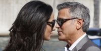 George Clooney, right, and his fiancee Amal Alamuddin arrive in Venice, Italy, Friday, Sept. 26, 2014. Clooney, 53, and Alamuddin, 36, are expected to get married this weekend in Venice, one of the world’s most romantic settings. (AP Photo/Luca Bruno)