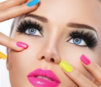 Beauty girl portrait with vivid makeup and colorful nail polish
