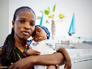 Young African emigrant mother with baby