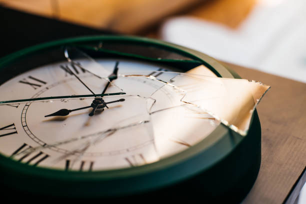 A wall clock with broken glass