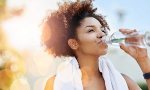 woman-in-nature-drinking-water-iStock-636083442-1024x614