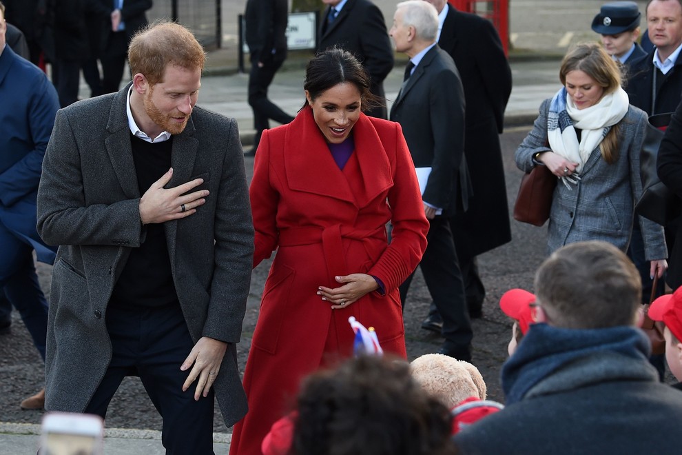 Britain's Prince Harry, Duke of Sussex (L) and Meghan, Duchess of Sussex greet wellwishers as they visit Birkenhead, northwest England on January 14, 2019. (Photo by PAUL ELLIS / AFP)