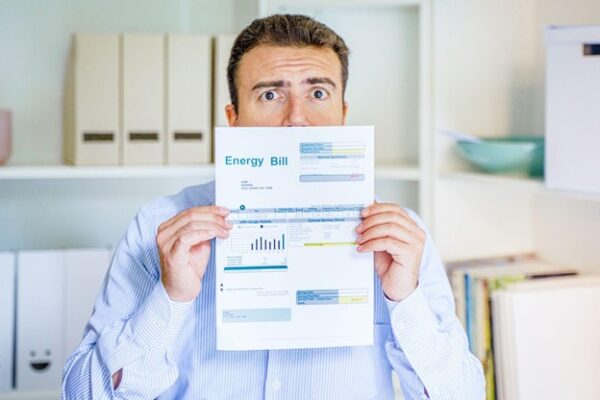 Reliant-Energy-Image-of-Man-Holding-up-Energy-Bill-600x400-1