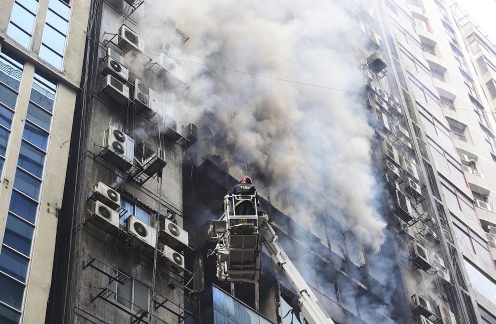 A firefighter works to douse a fire in a multi-storied office building in Dhaka, Bangladesh, Thursday, March 28, 2019. Fire Department control room official Ershad Hossain said by phone the FR Tower in Dhaka's Banani commercial district caught fire Thursday afternoon and at least 19 fire fighting units joined the operation to douse the blaze and rescue the people trapped inside. (ANSA/AP Photo/Mahmud Hossain Opu )