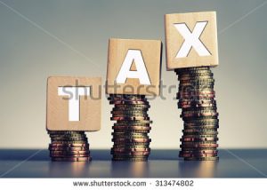 stock-photo-tax-concept-with-wooden-block-on-stacked-coins-313474802[1]