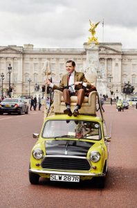 Mr Bean, played by Rowan Atkinson, celebrates the character's 25th anniversary by driving down The Mall in front of Buckingham Palace, London, on his trademark Mini. PRESS ASSOCIATION Photo. Picture date: Friday September 4, 2015. To coincide with the anniversary the Ultimate Collection DVD boxset is available from Monday 7 September and new animated Mr Bean episodes arrive on Boomerang on Saturday 5 September. Photo credit should read: John Stillwell/PA Wire
